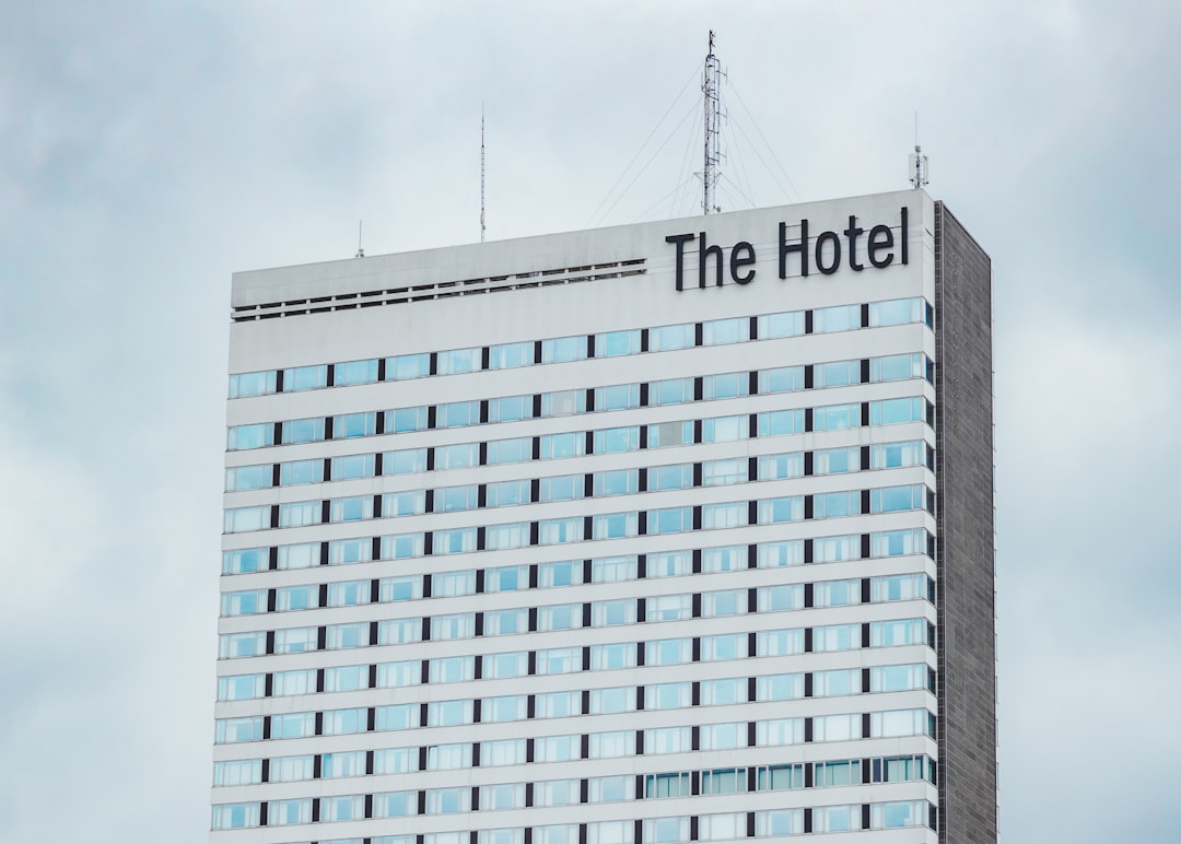a tall building with a sign on top of it,