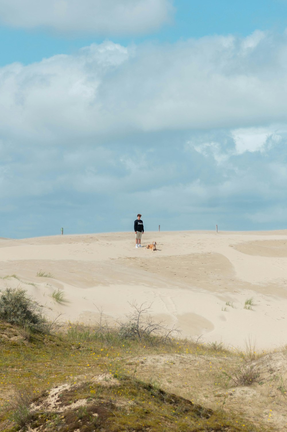 a man standing on top of a sandy beach