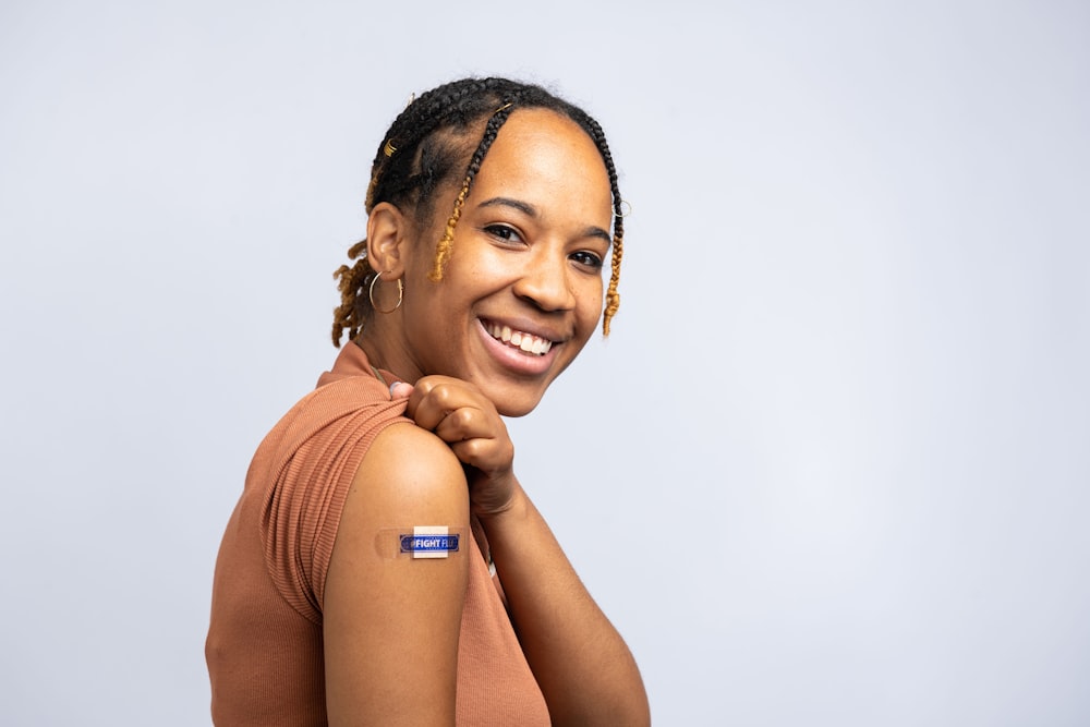 a smiling woman with braids on her hair