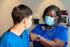 a woman in a blue scrub suit and a man in a blue scrub suit
