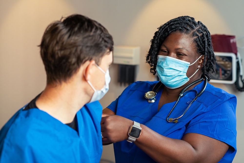 a woman in a blue scrub suit and a man in a blue scrub suit