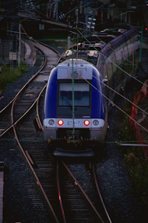 A panoramic view of a newly modernized train rolling stock on polished tracks at dawn