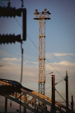 a tall tower sitting next to a train track