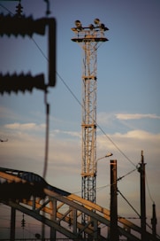 a tall tower sitting next to a train track
