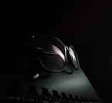 a pair of glasses sitting on top of a computer keyboard