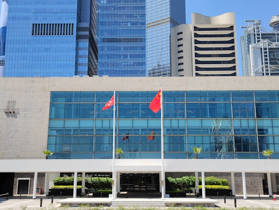 A sleek modern office building with international flags representing global business connections.