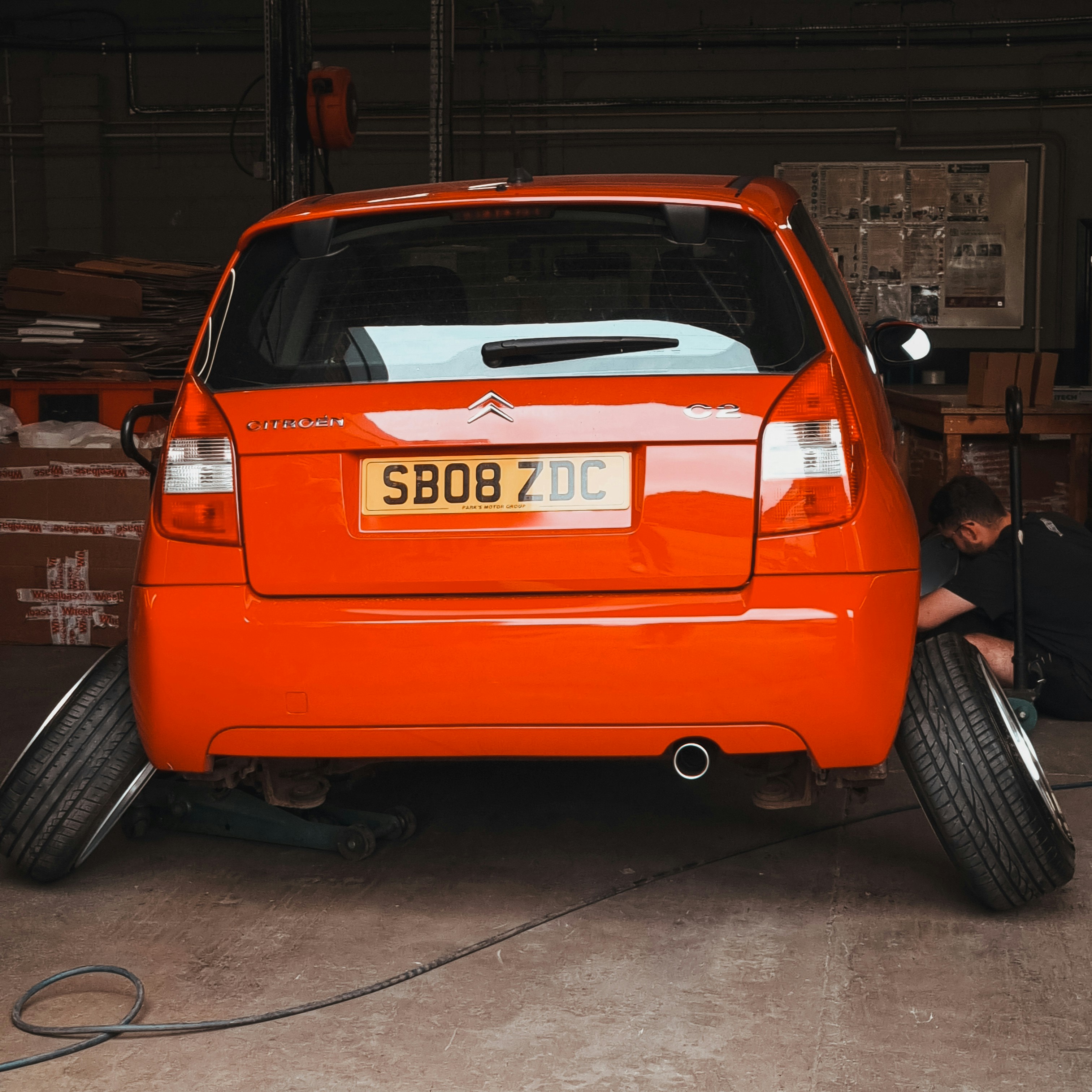 a man working on a car in a garage