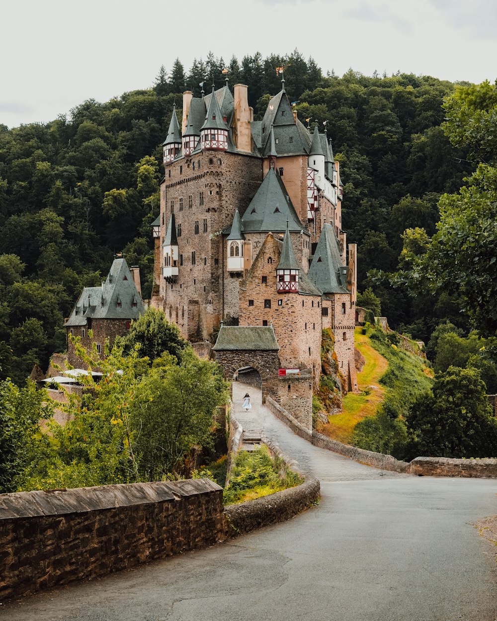 a large castle with a long driveway leading to it