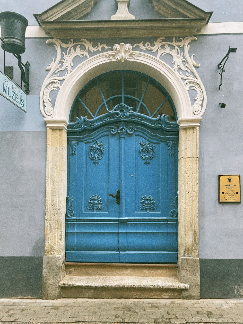 a blue door with a white arch above it