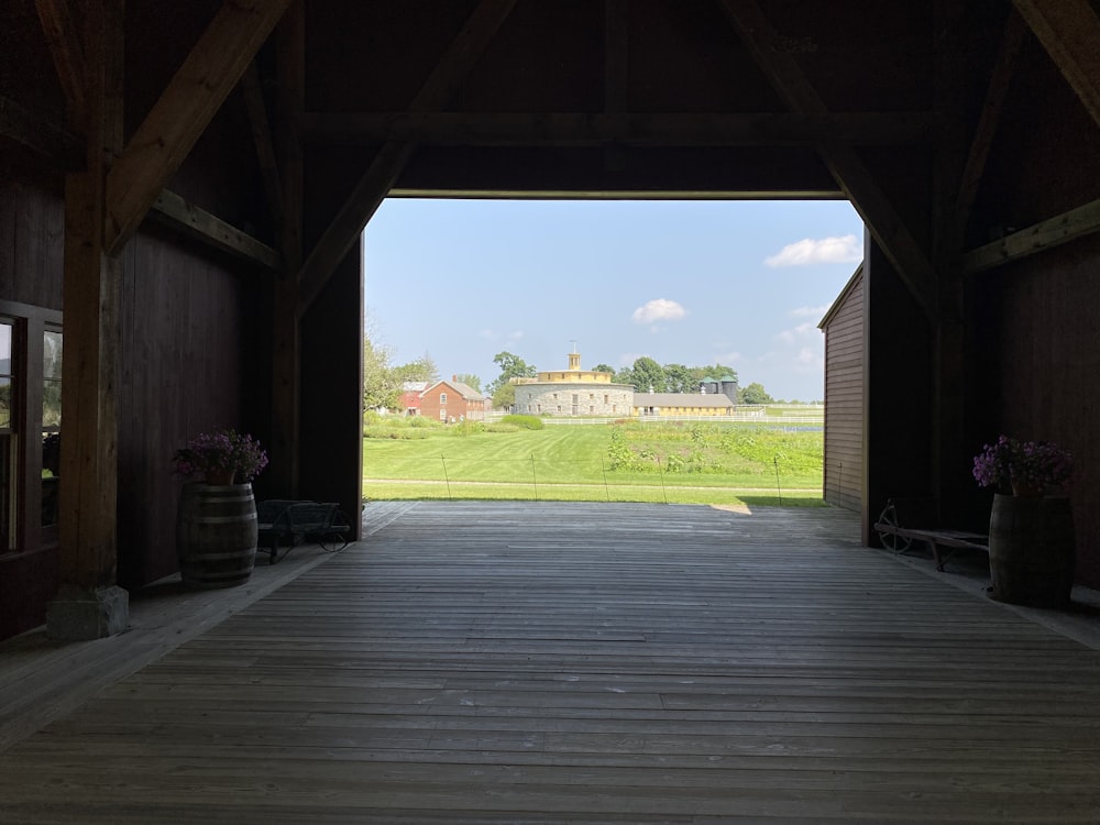 a wooden walkway leading to a barn with a barn in the background