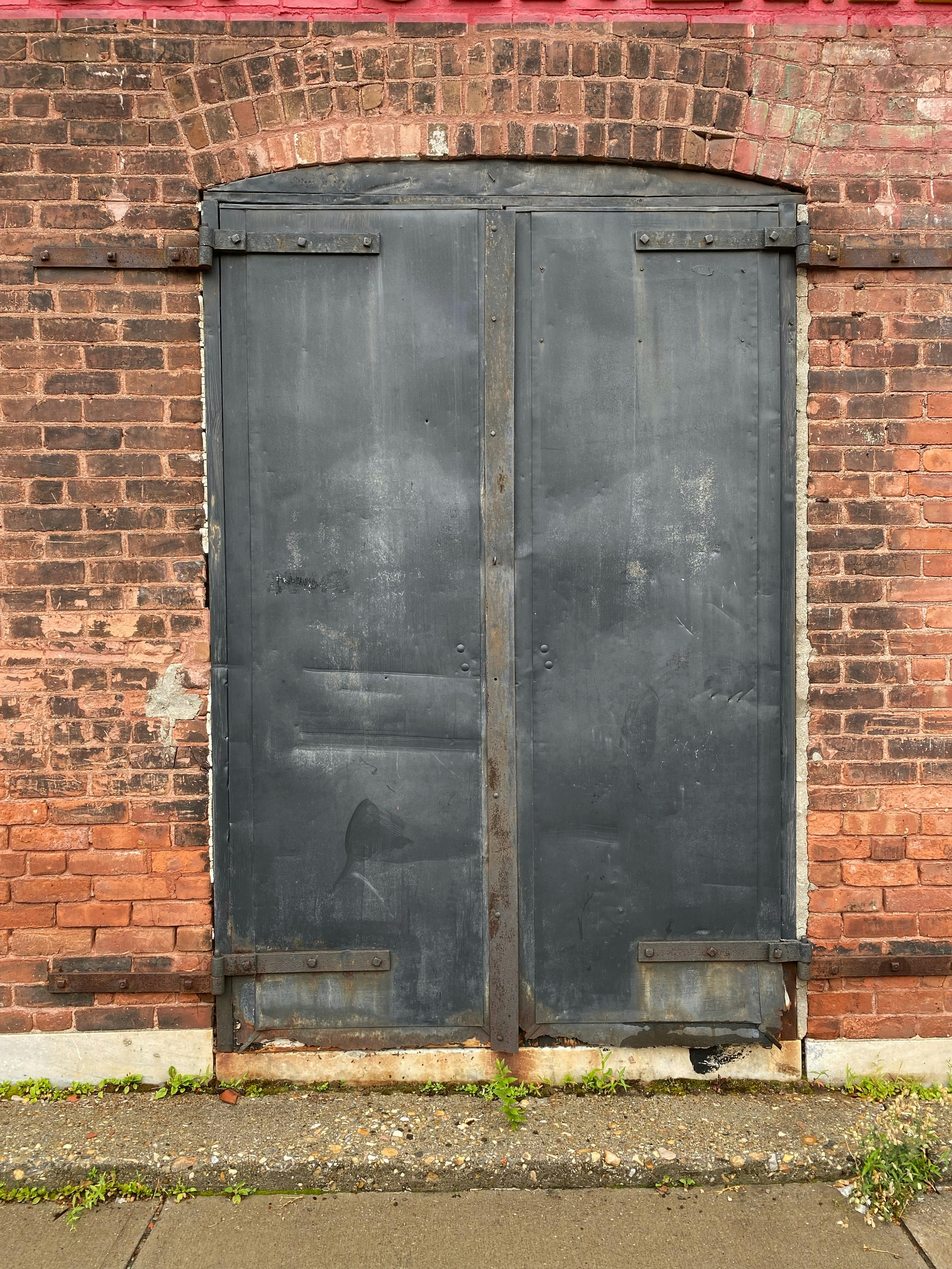 a brick building with a large metal door