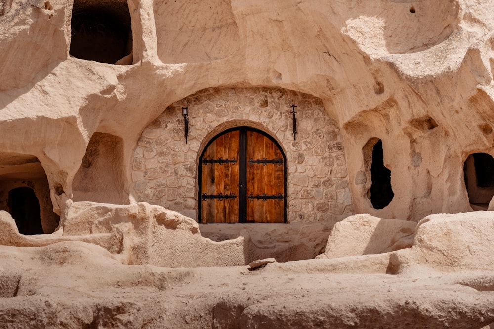 a building made of rock with a wooden door