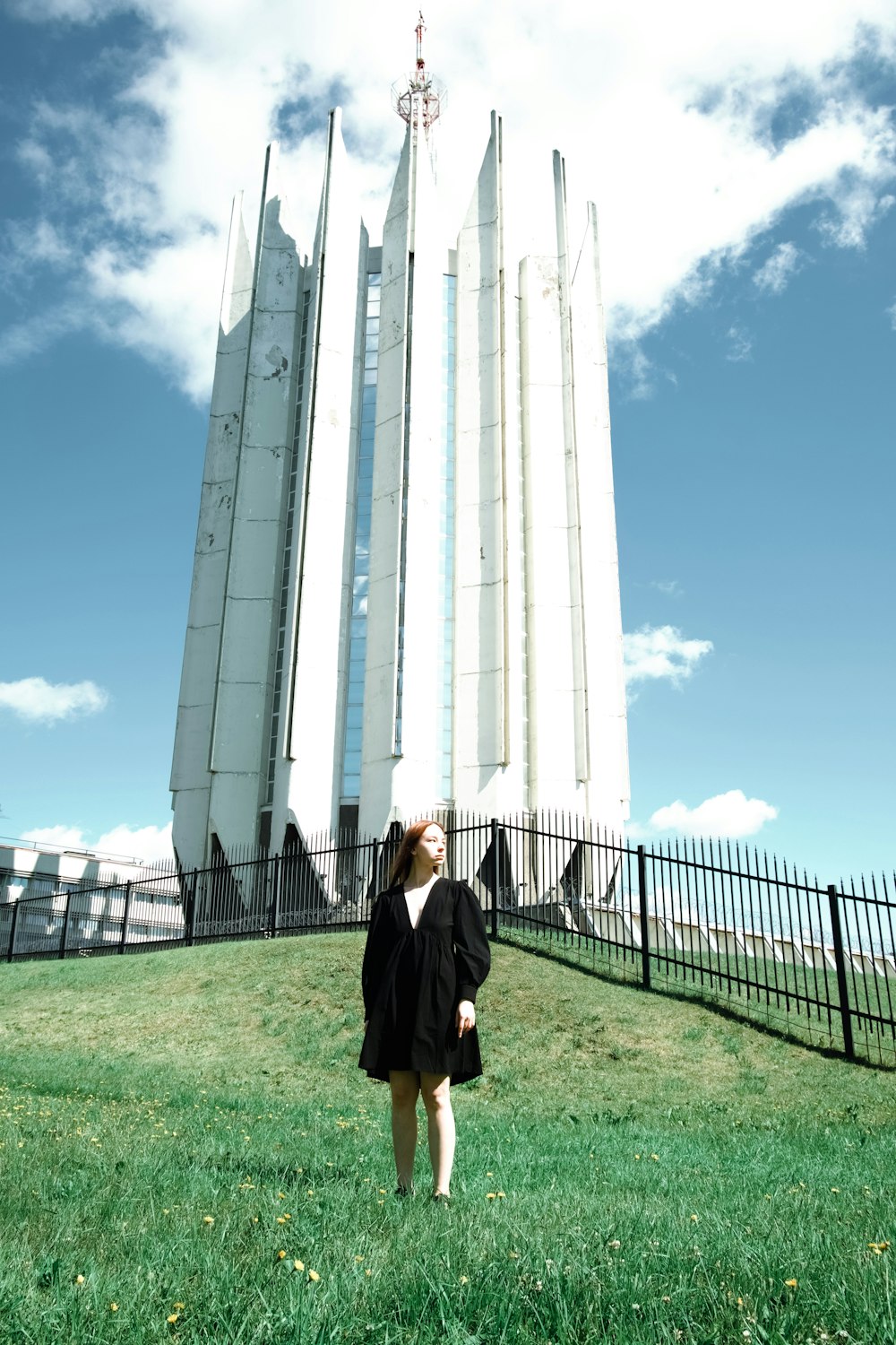 a woman standing in front of a tall building