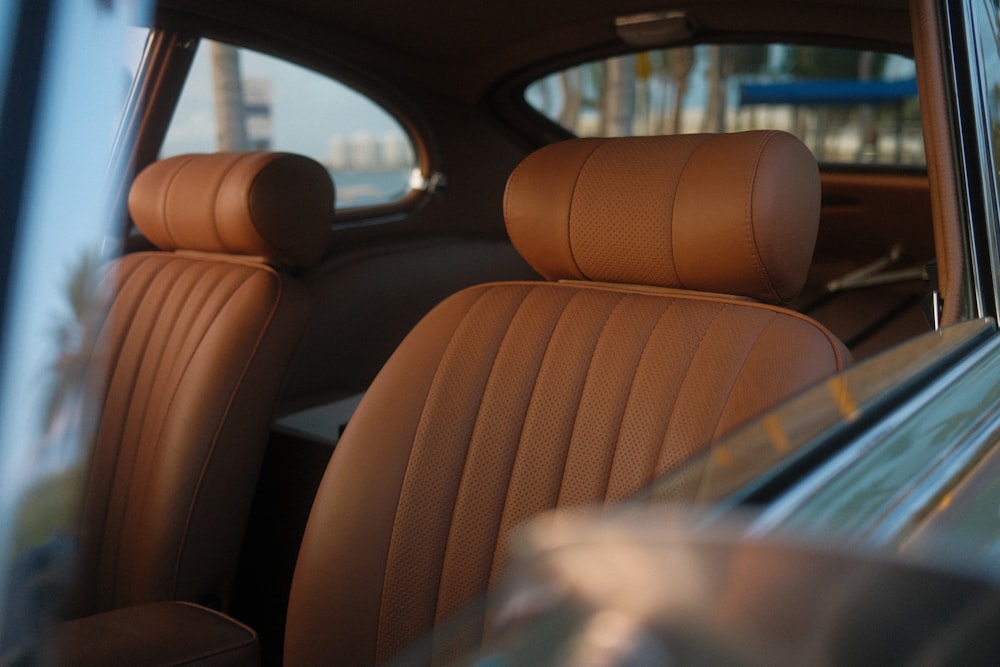 the interior of a car with brown leather seats