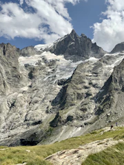 Mountain landscape with hikers and clear blue sky