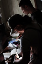 Close-up of hands reviewing real estate documents over a clean, modern desk.