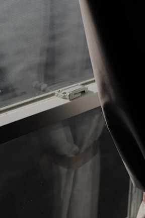 Evening shot showing a bedroom window secured with a velcro mosquito net in chennai