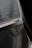 Close-up of a newly installed mosquito net on a balcony window with sunlight filtering through.