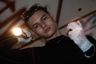 A technician inspecting air ducts with a flashlight.