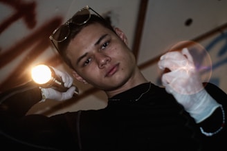 A technician inspecting air ducts with a flashlight.