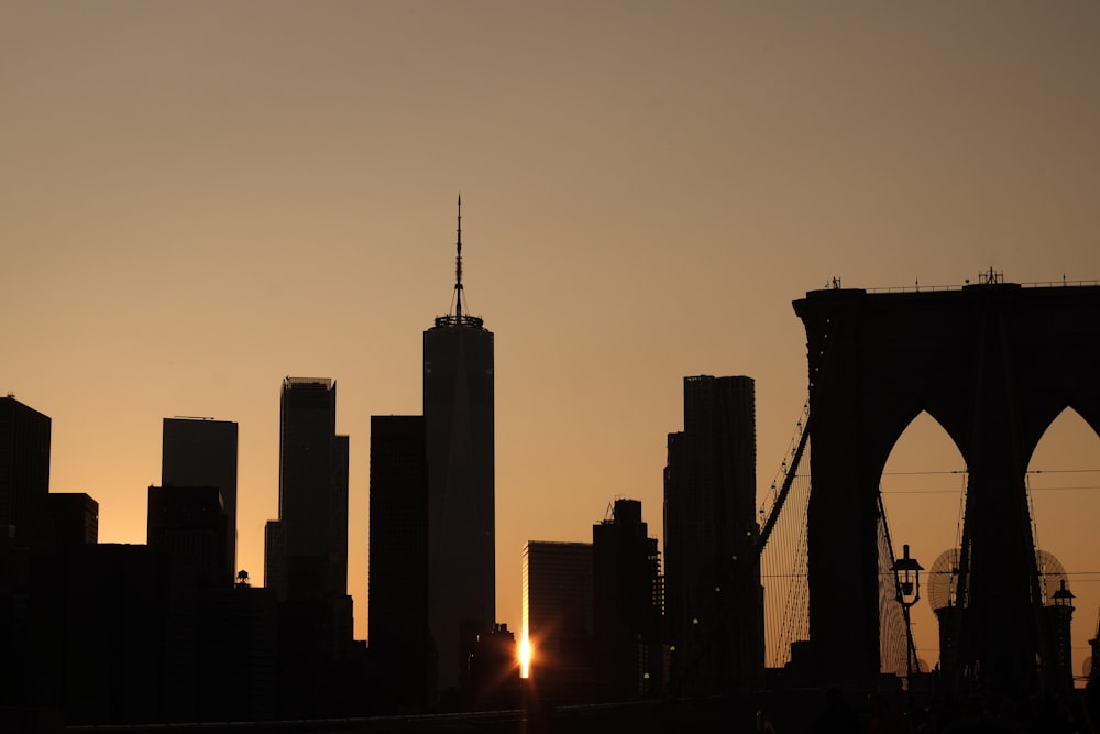 the sun is setting over the city skyline