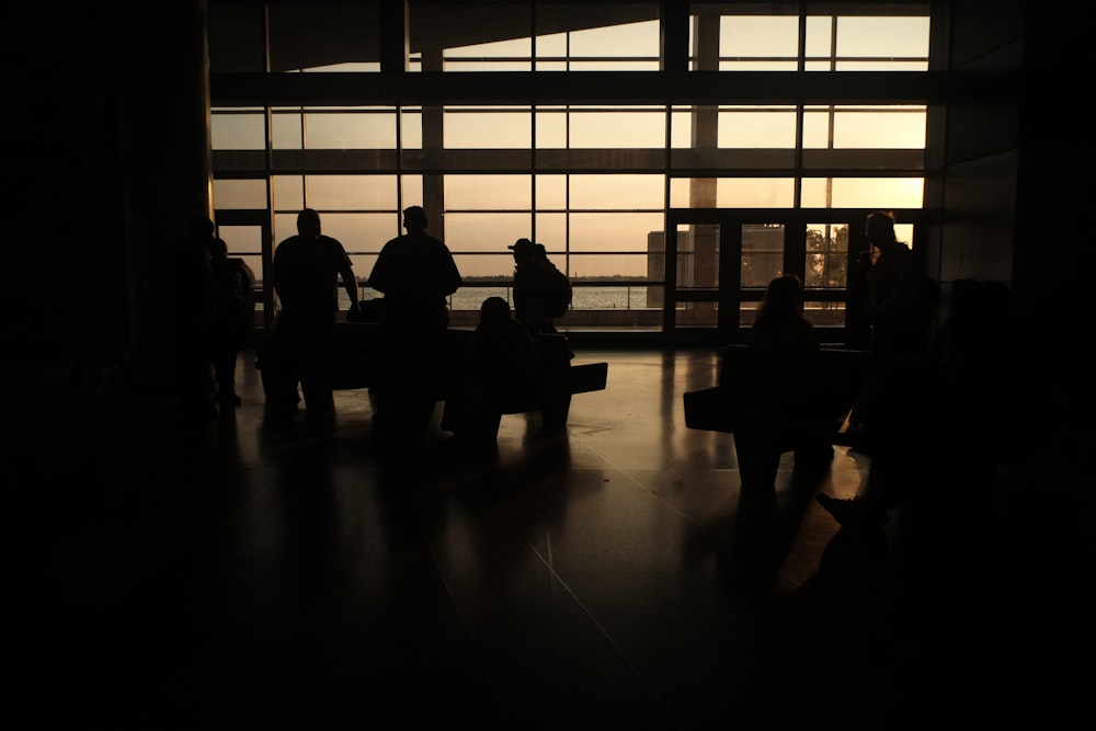 a group of people standing around a window in a building