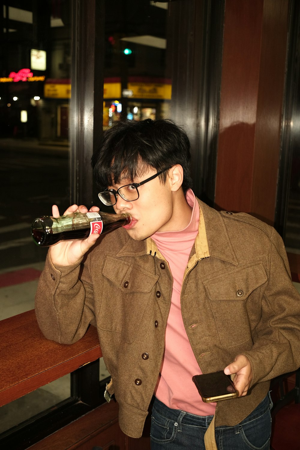a man drinking from a bottle of wine