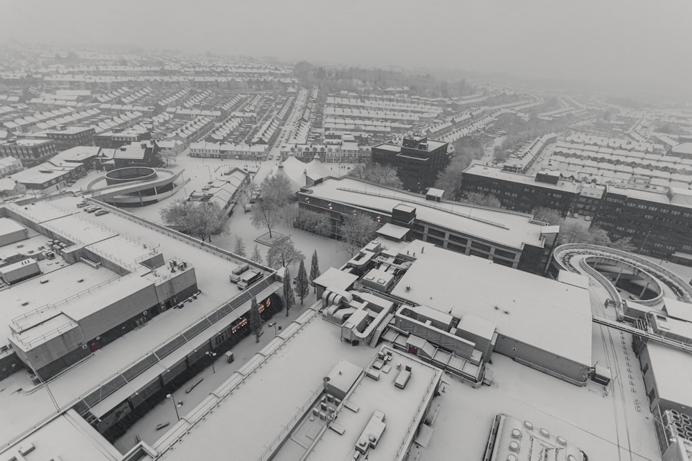 a black and white photo of a snowy city