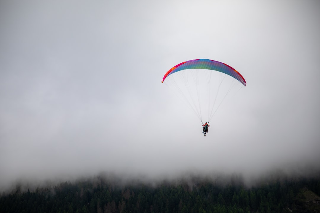 a person is parasailing on a cloudy day,