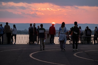 A happy couple enjoying a scenic sunset on a group trip with other couples