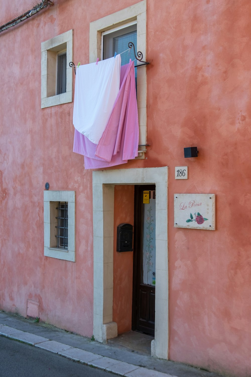 a pink building with a clothesline hanging out to dry