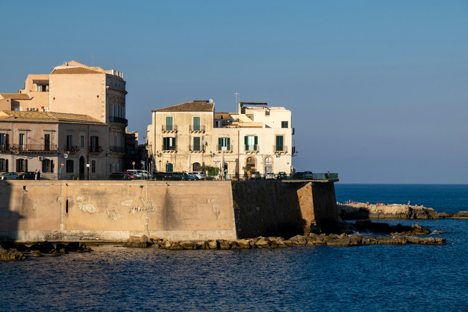 Pale stone palazzi above the old sea wall of Ortigia, Syracuse's island center