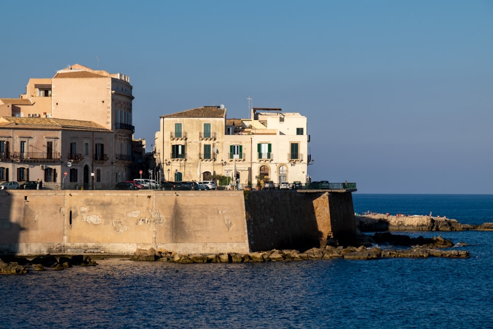 a group of buildings sitting next to a body of water