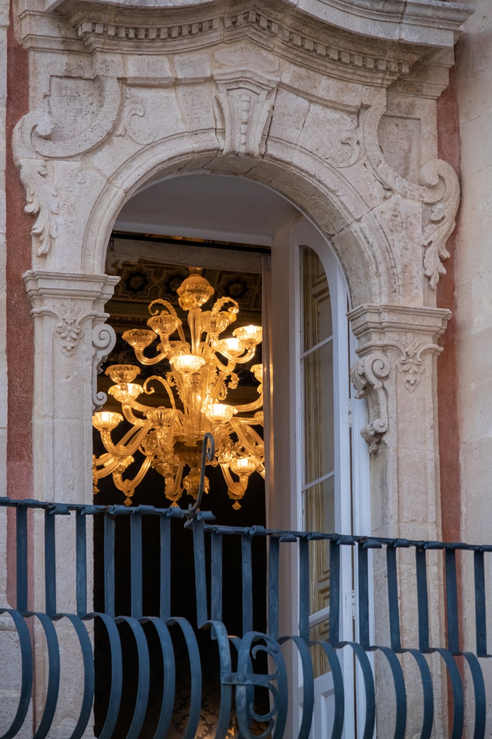 a chandelier hanging from the side of a building