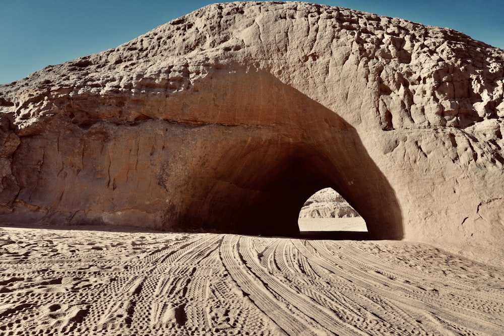 a large rock formation with a tunnel in the middle of it