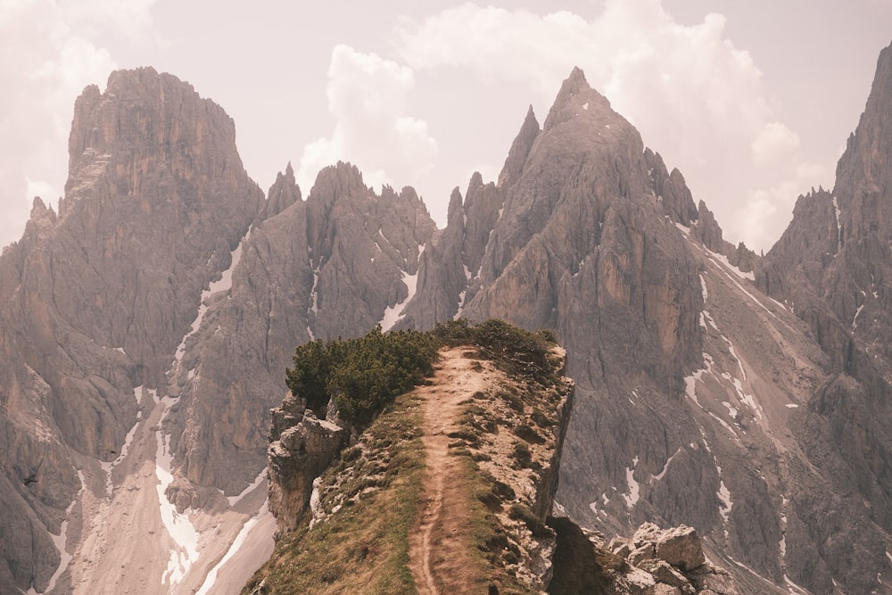 a dirt path going up a mountain side