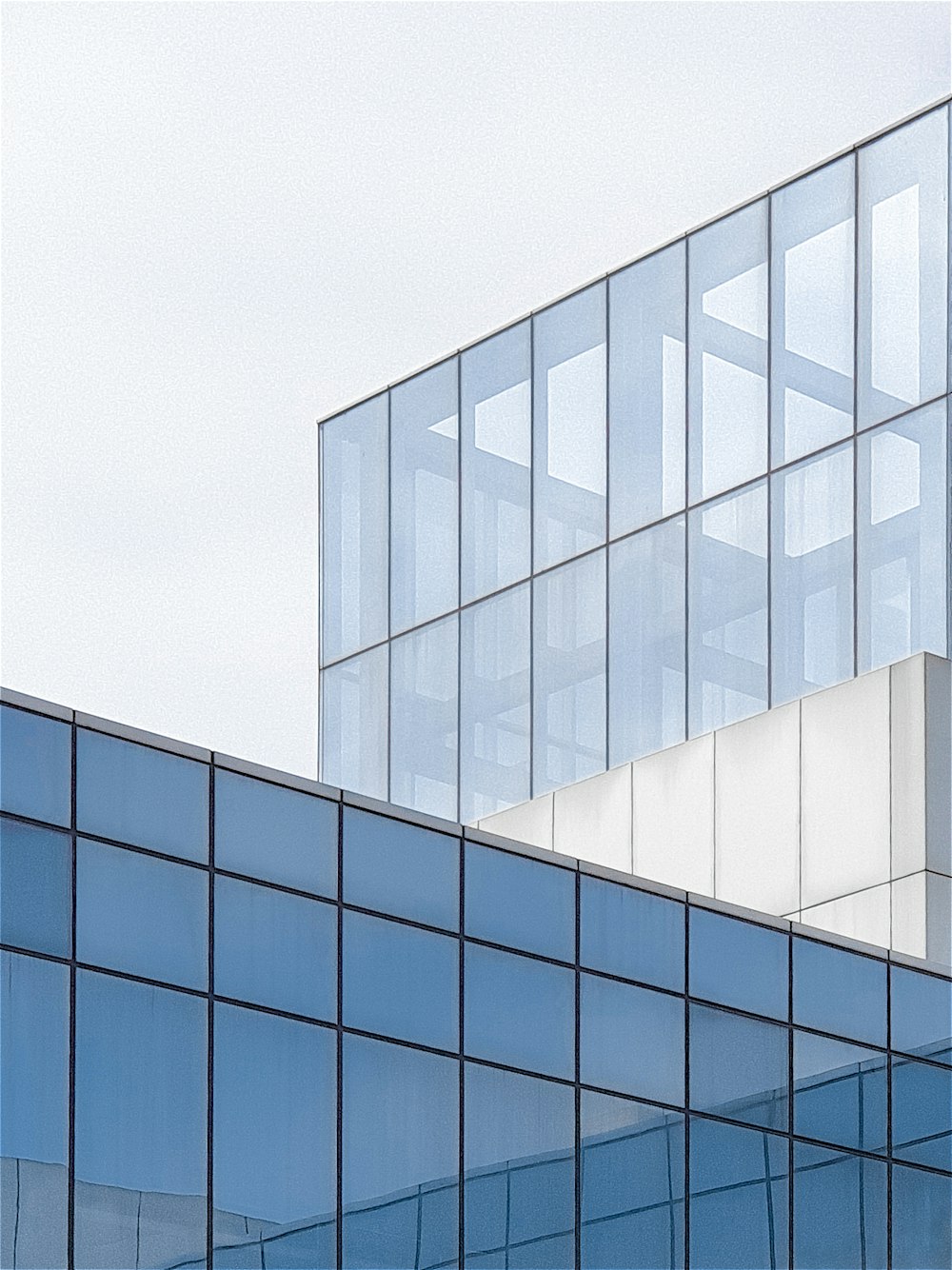 an airplane is flying over a glass building