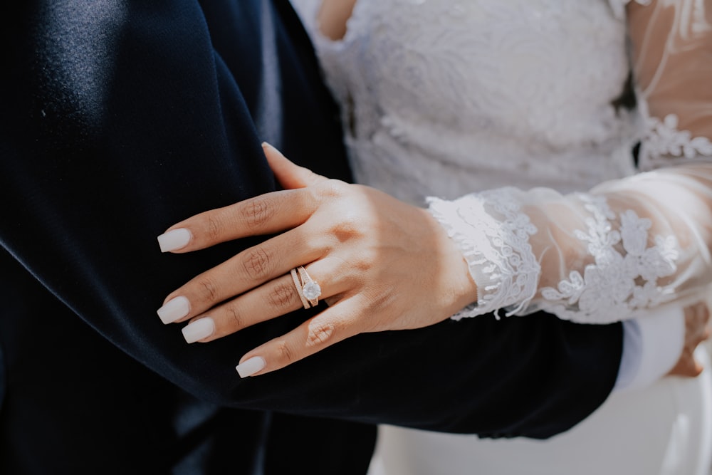 a close up of a person wearing a wedding ring