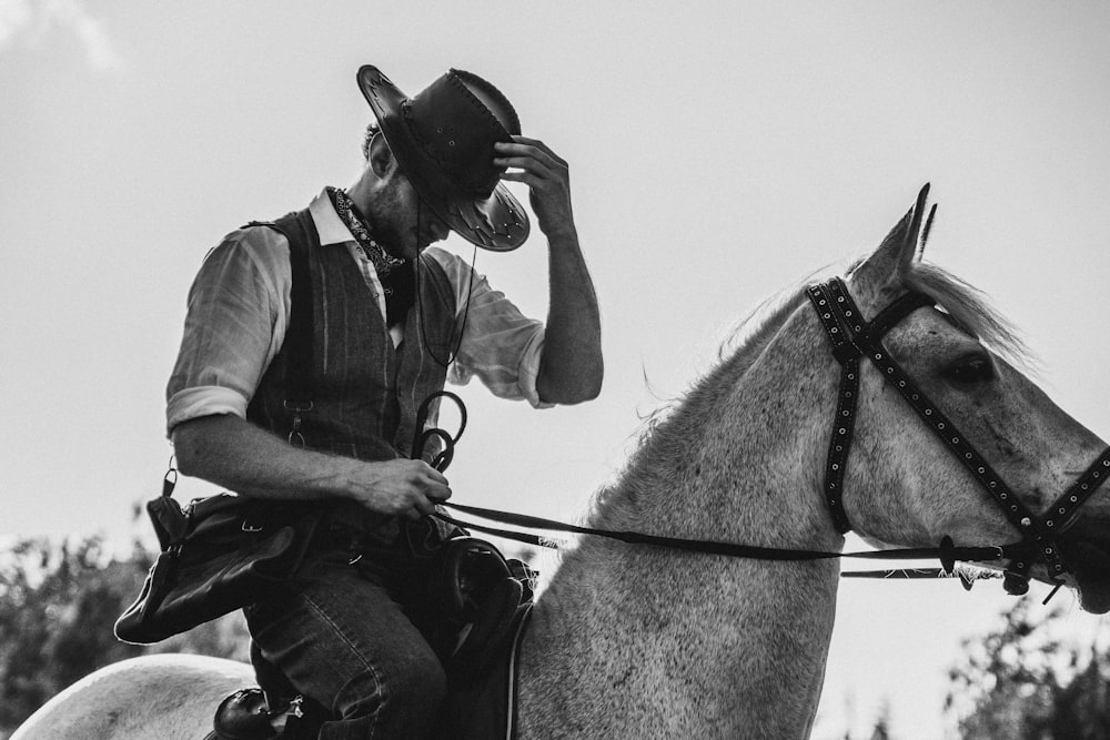 a man riding on the back of a white horse