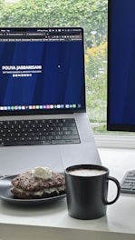 A midnight blue and charcoal themed desktop setup showing movie review notes and a glowing metallic gold cup of coffee.