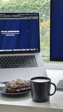 A midnight blue and charcoal themed desktop setup showing movie review notes and a glowing metallic gold cup of coffee.