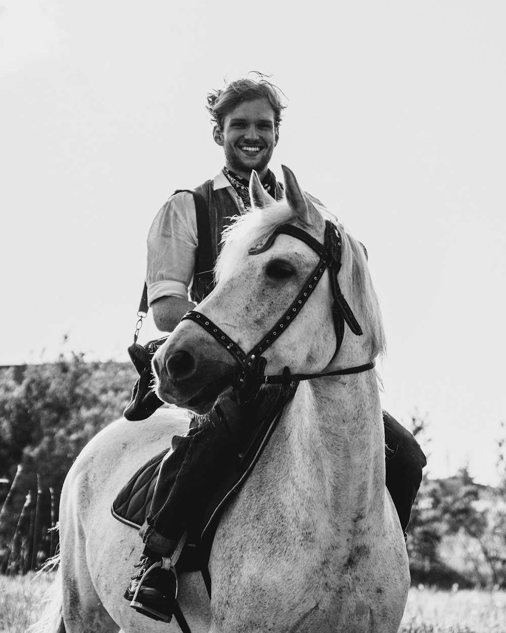 a man riding on the back of a white horse