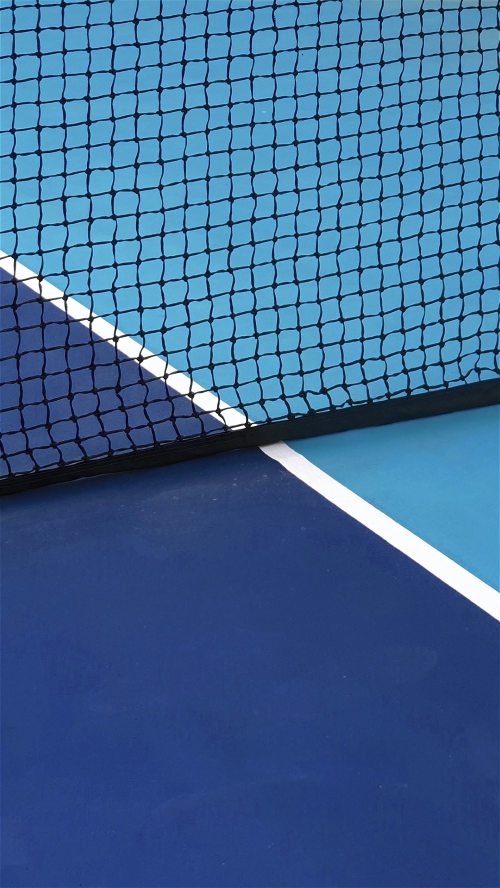 a blue tennis court with a white line on it
