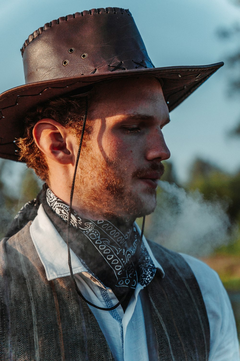 a man wearing a hat and a neck tie