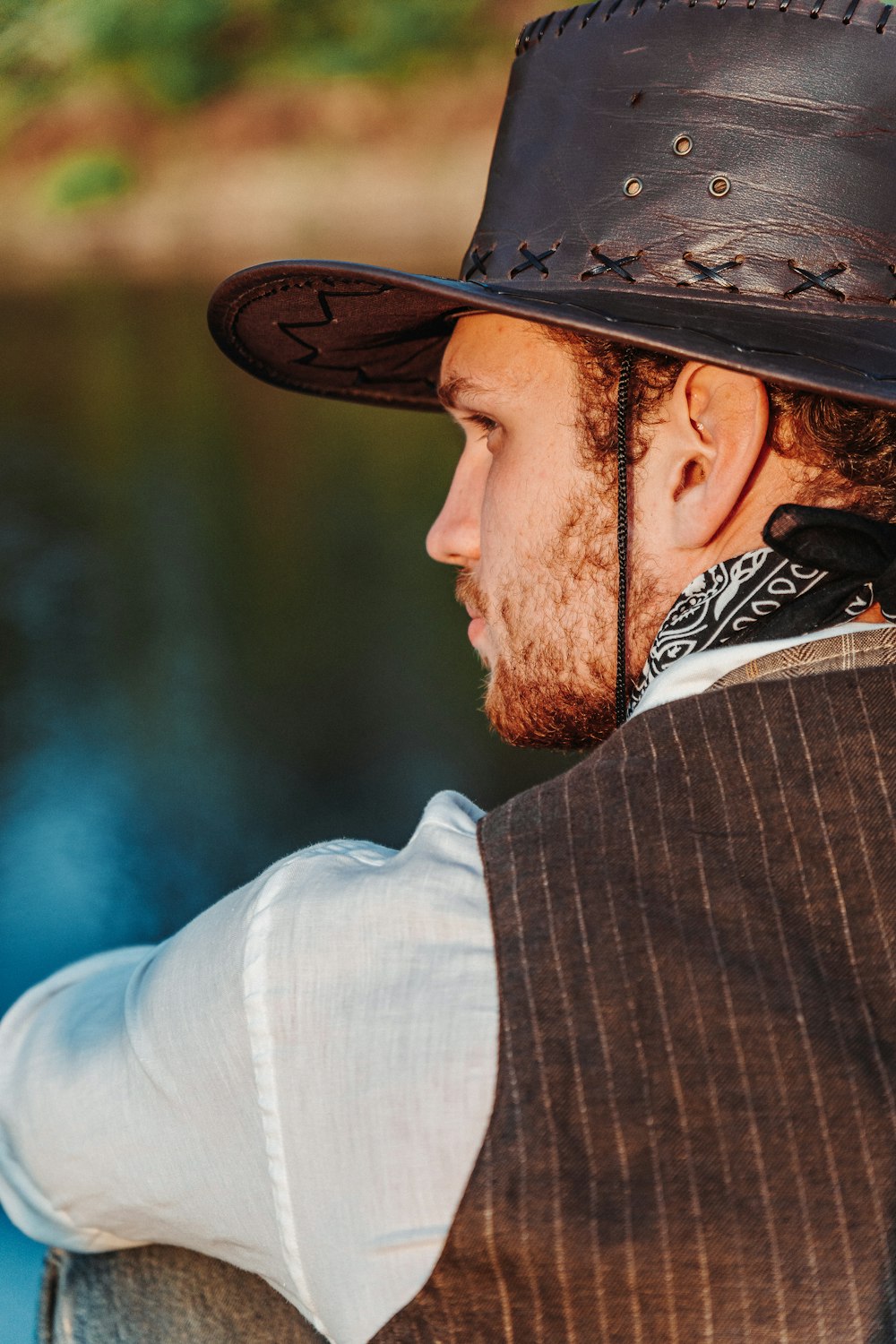 a man with a beard wearing a brown hat