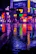 Urban night scene with glowing neon signs reflecting off wet pavement.