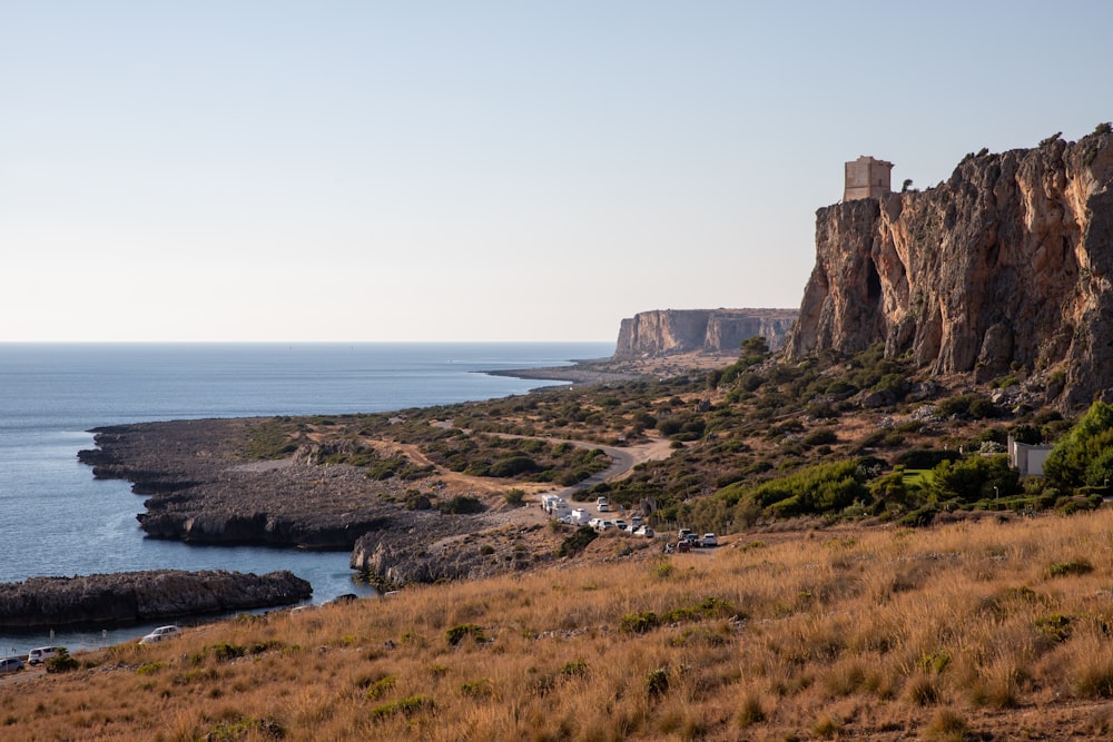 a rocky cliff overlooks a body of water