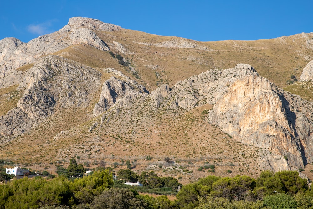 a mountain range with a house in the foreground