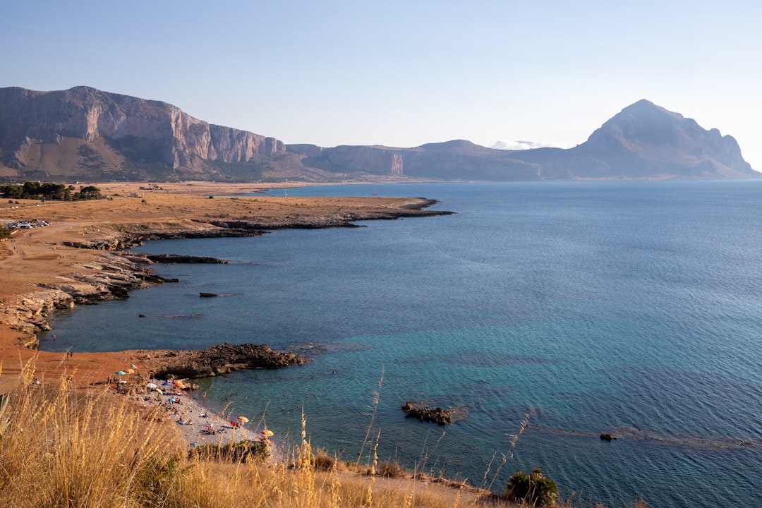 a large body of water surrounded by mountains, Macari Viewpoint & Breathtaking View of Mountain Cofano