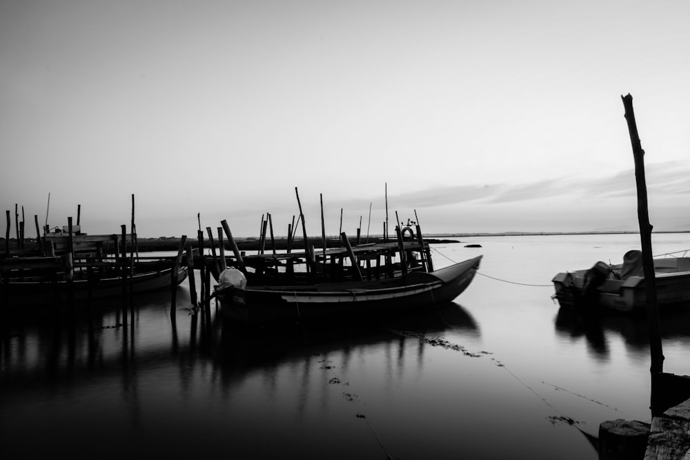 a black and white photo of several boats in the water